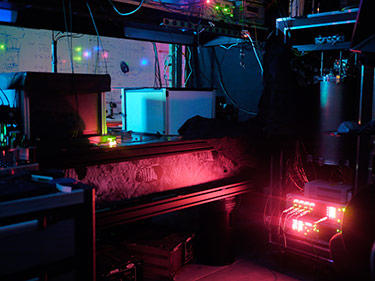 University of Waterloo laboratory where scientists entangled three photons. NIST's single-photon detectors were chilled to near absolute zero in the refrigerator (large blue cylinder).