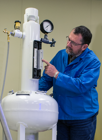 Val Miller demonstrates volume instrument.