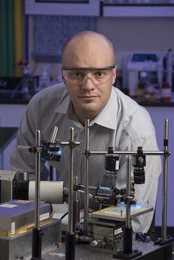 Wyatt Vreeland, wearing safety goggles and standing at a lab bench