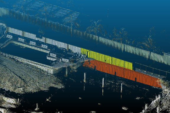 Lidar image of building collapse site looks like a black-and-white photo with some parts of the remaining walls marked in yellow and red.
