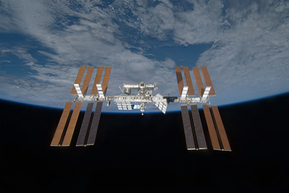 View of the International Space Station with the curve of the Earth in the background. 