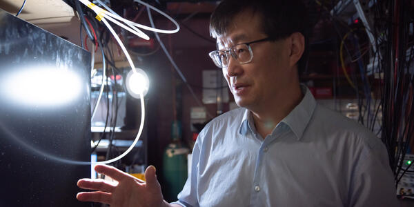 Side shot of Jun Ye in his lab