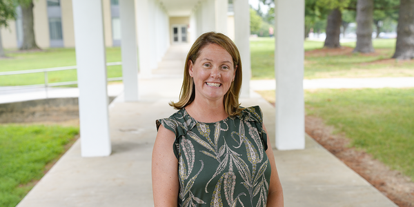 Erica Romsos poses outdoors on the NIST campus. 