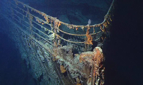 Photo of the bow of the RMS Titanic on the ocean floor with rust, sea growth