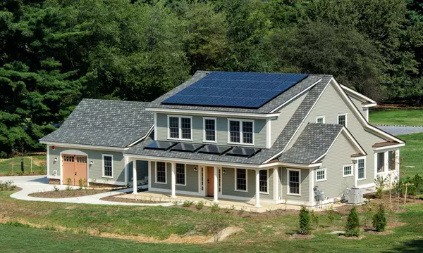 photo of a house. Solar panels on the roof.
