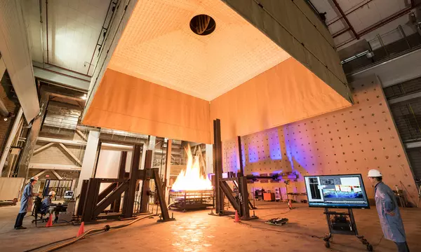 NIST engineers operate various imaging systems to document a structure’s behavior during a fire test.