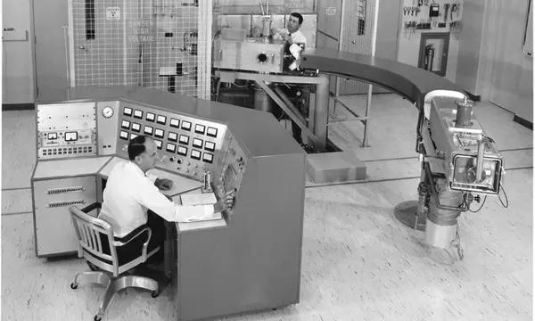 Two men in a room full of scientific equipment