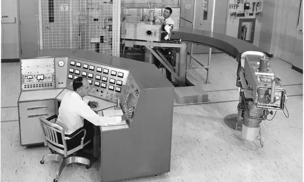 Two men in a room full of scientific equipment