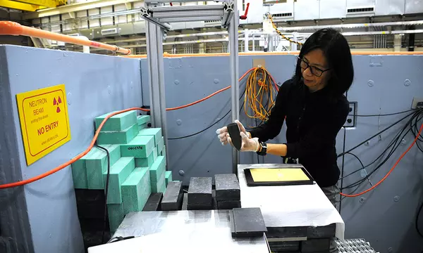 Heather Chen-Mayer loading a jade artifact into a neutron detector
