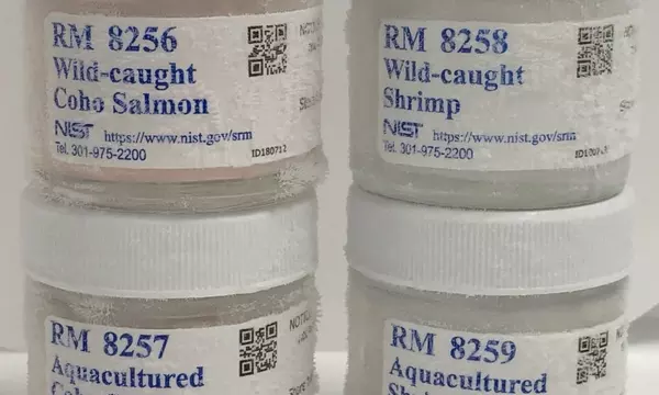 Picture of jars containing reference materials 8256, 8257, 8258, and 8259: Wild caught and aquacultured shrimp and salmon