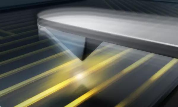 Illustrated metallic tip of an atomic force microscope hovers over a microcircuit on a chip.