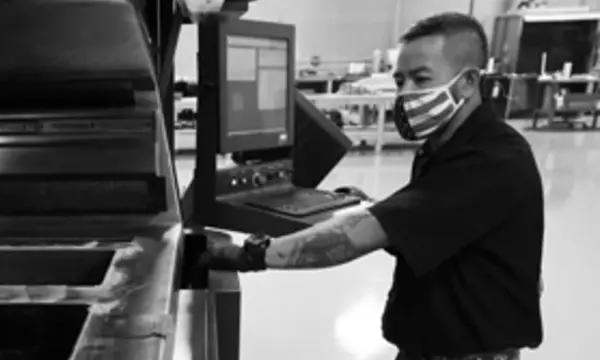 manufacturing employee working on equipment