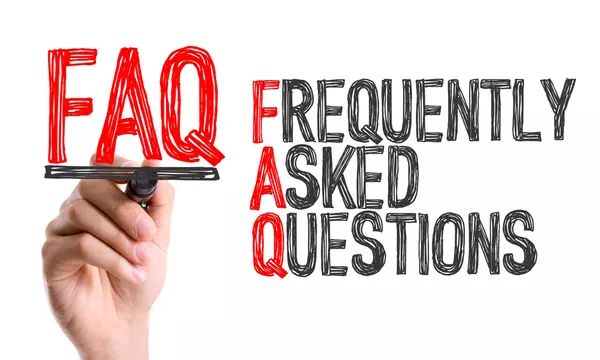 Hand holding red letters FAQ, Frequently Asked Questions