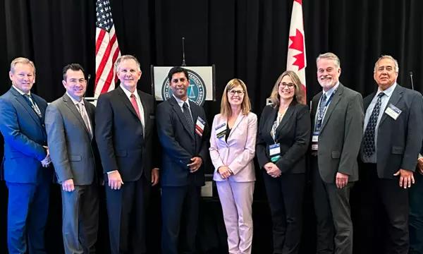 group photo taken at NCWM 2023 Annual Meeting; Craig VanBuren, Don Onwiler, and Mahesh Albuquerque of NCWM, Laurie Locascio and Katrice Lippa of NIST, Gene Robertson of NCWM, David Sefcik