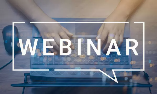 Webinar image with hands over laptop in background