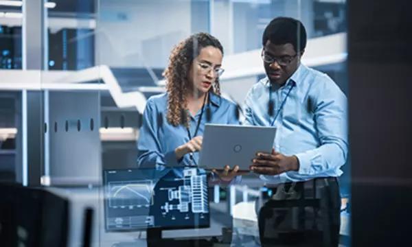 Multiethnic Robotics Engineer Talking to Project Manager