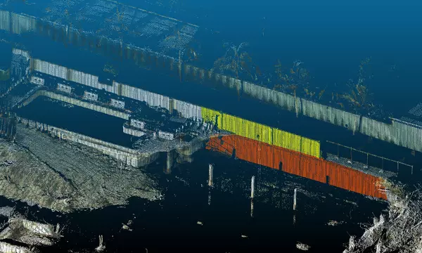 Lidar image of building collapse site looks like a black-and-white photo with some parts of the remaining walls marked in yellow and red.
