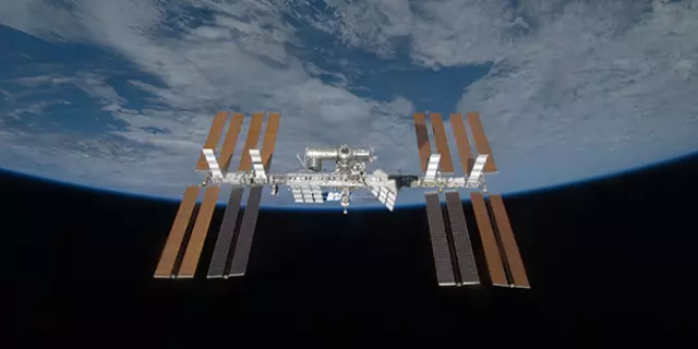 View of the International Space Station with the curve of the Earth in the background. 