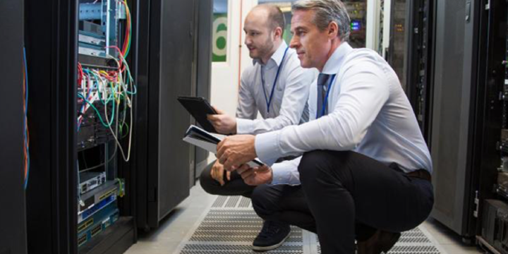 two men looking at a computer