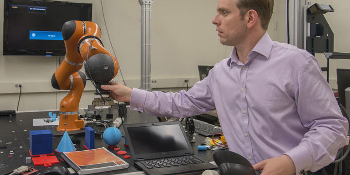 Jeremy Marvel adjusts robotic arm