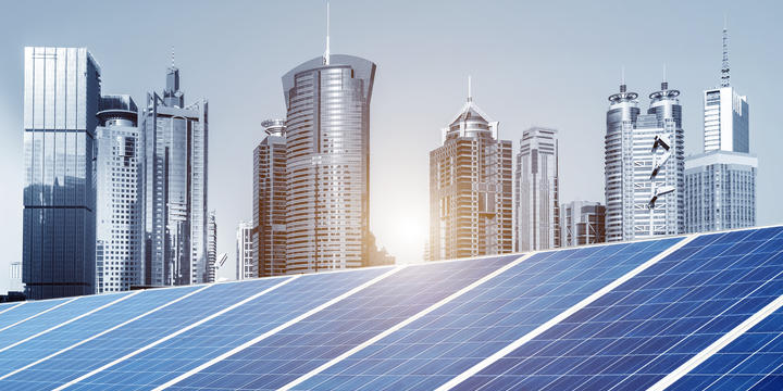 Cityscape in the background. Solar panels in the foreground.