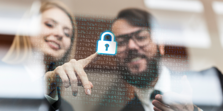 Employees pressing a lock icon representing cybersecurity