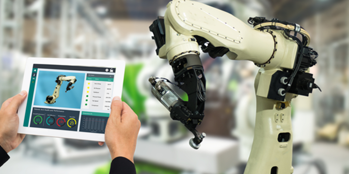 manufacturer with an ipad controlling a robot