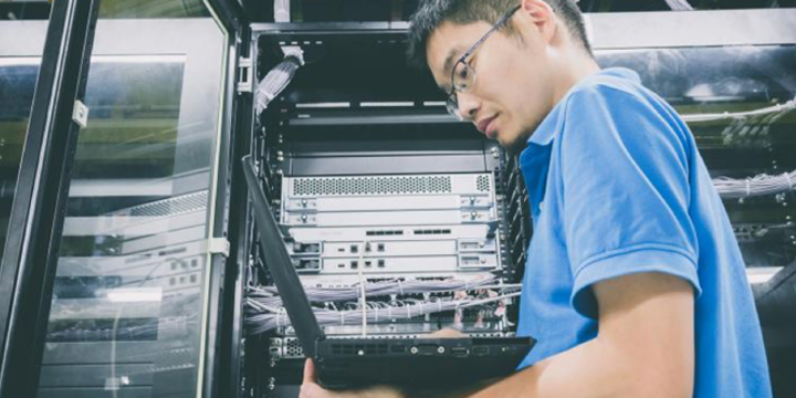 man looking at a computer to detect a cybersecurity attack