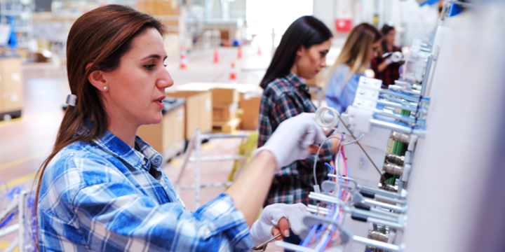 Female manuel workers team working on the production line in factory stock photo