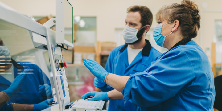 Production factory workers in the current health environment wearing masks 