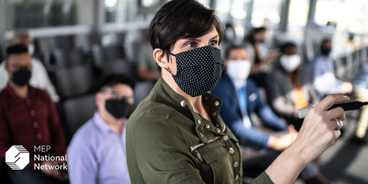 Businesswoman speaking at a business conference with face masks