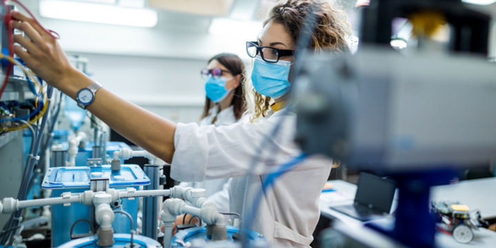 Female engineers with face masks working in laboratory