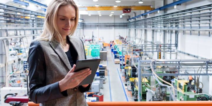 female manufacturing worker on a tablet with advanced manufacturing technologies