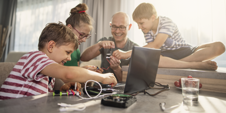 Father and kids enjoying coding and electronics at home