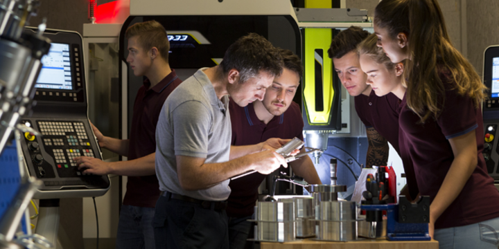 Group of student apprentices in a manufacturing facility