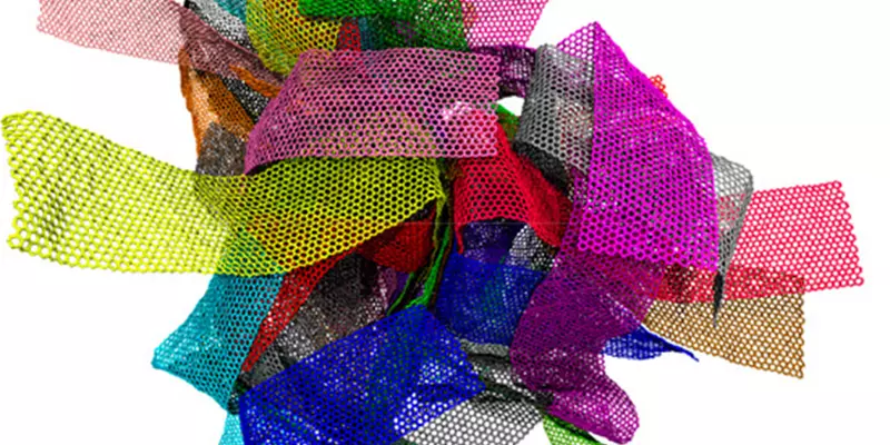 Many different rectangular pieces of webby material are all wrapped up in a big ball. The pieces are each colored differently so that you can tell them apart in the bunch. These are meant to represent a graphene melt.