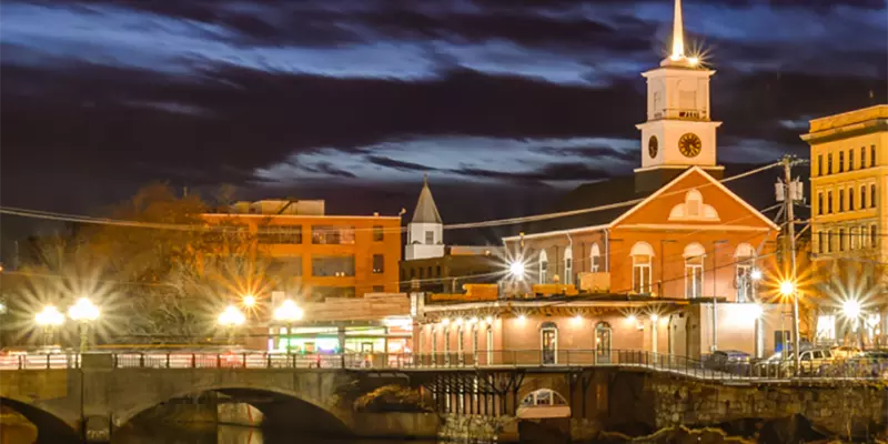 streetlight lit scene of buildings on a waterfront at night