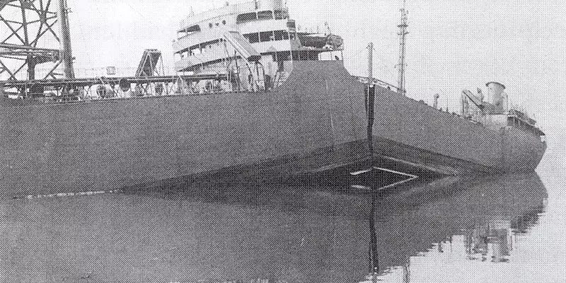 Historical newspaper photo shows a large ship in port with a crack down the center, splitting it almost in half. 