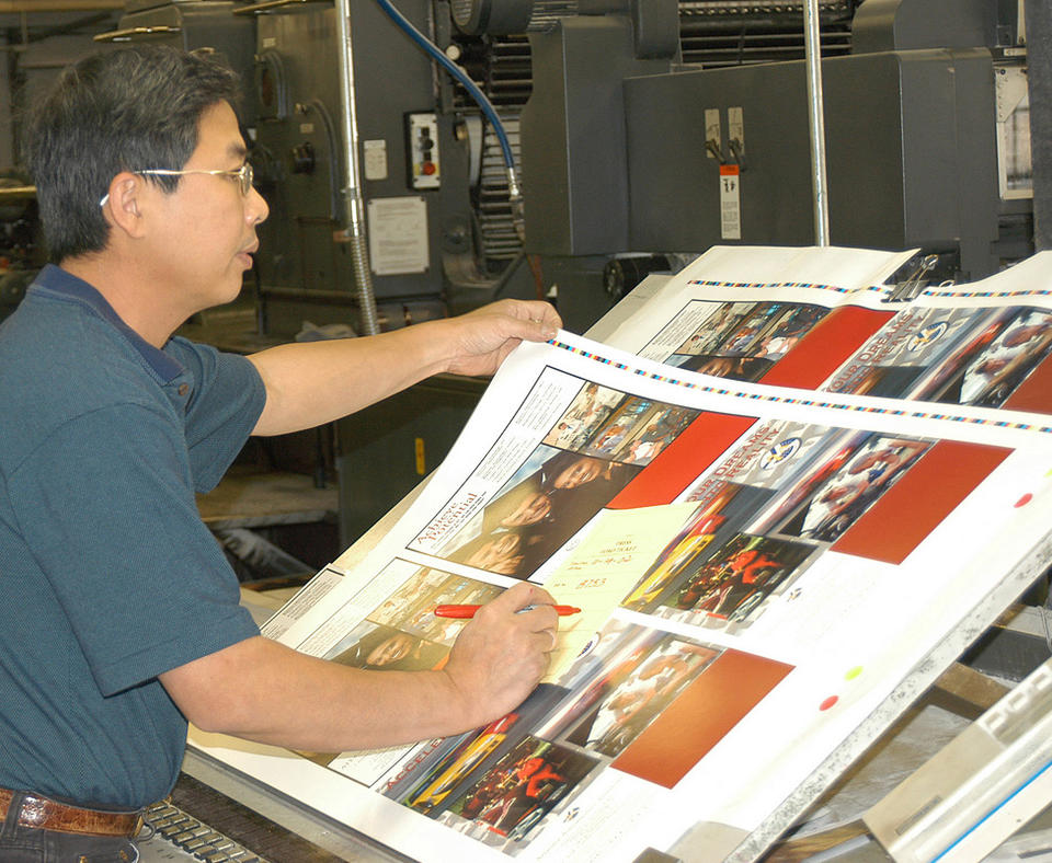 Branch-Smith Printing Division photo of man proofing press sheets.