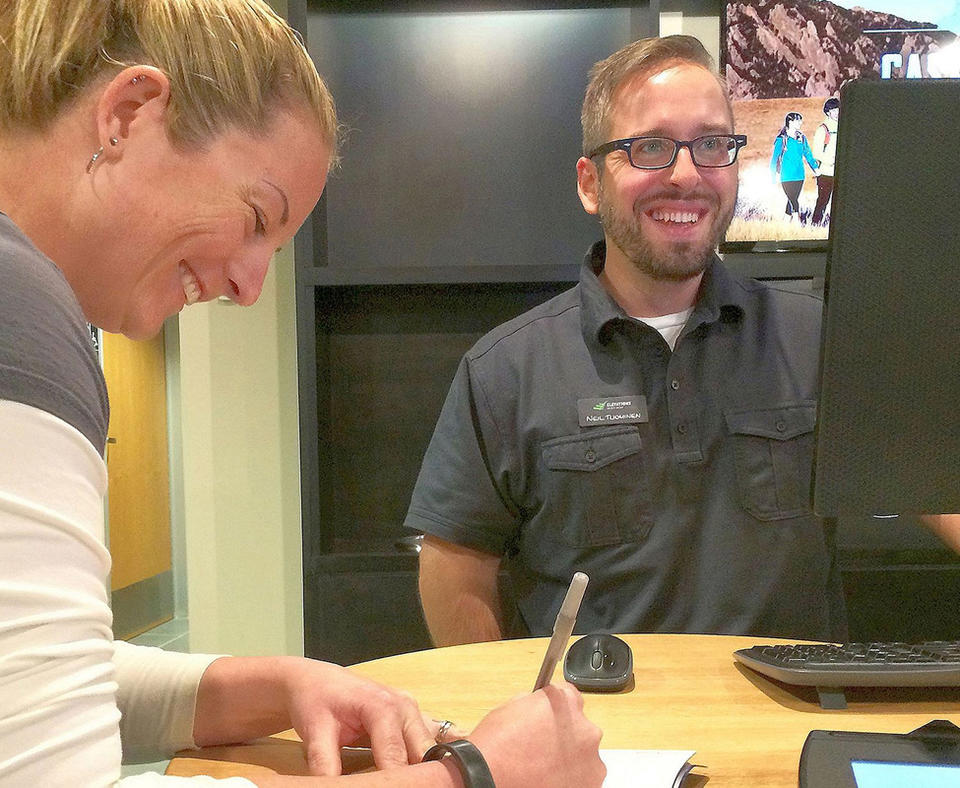 Elevations Credit Union photo with man and woman doing a bank transaction.