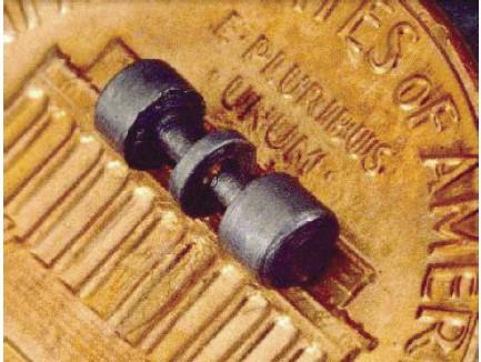 This image shows the electrodes of an ion trap used to trap mercury ions.  The electrodes are placed on a US penny to show scale, and are about the size of the text "E Pluribus Unum".