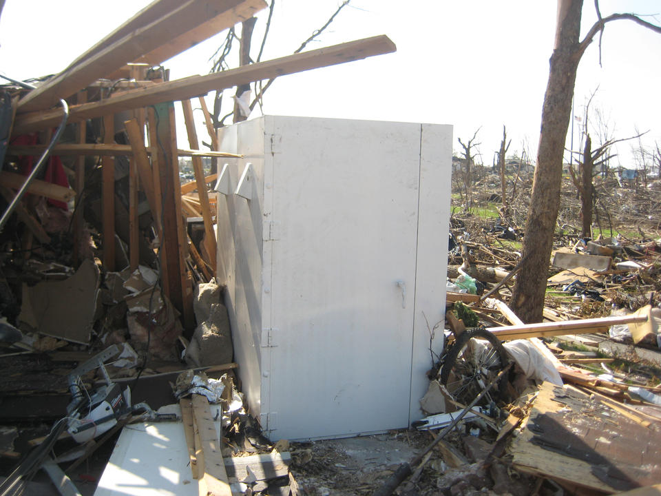 A steel shelter bolted to a concrete garage floor was all that remained of a wood-frame home destroyed in the Joplin, Mo., tornado of May 22, 2011. 