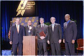 Pictured (Left to right): Commerce Secretary Don Evans; Quinton C. Van Wynen, president of the board of education, Pearl River School District; Richard Maurer, superintendent of schools, Pearl River School District; President Bush; Education Secretary Rod