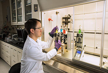 researcher Edwin Chan is using an instrument called the MDUSA (Multi Deposition Unassisted Spin Assembly) to create model filtration membrane materials