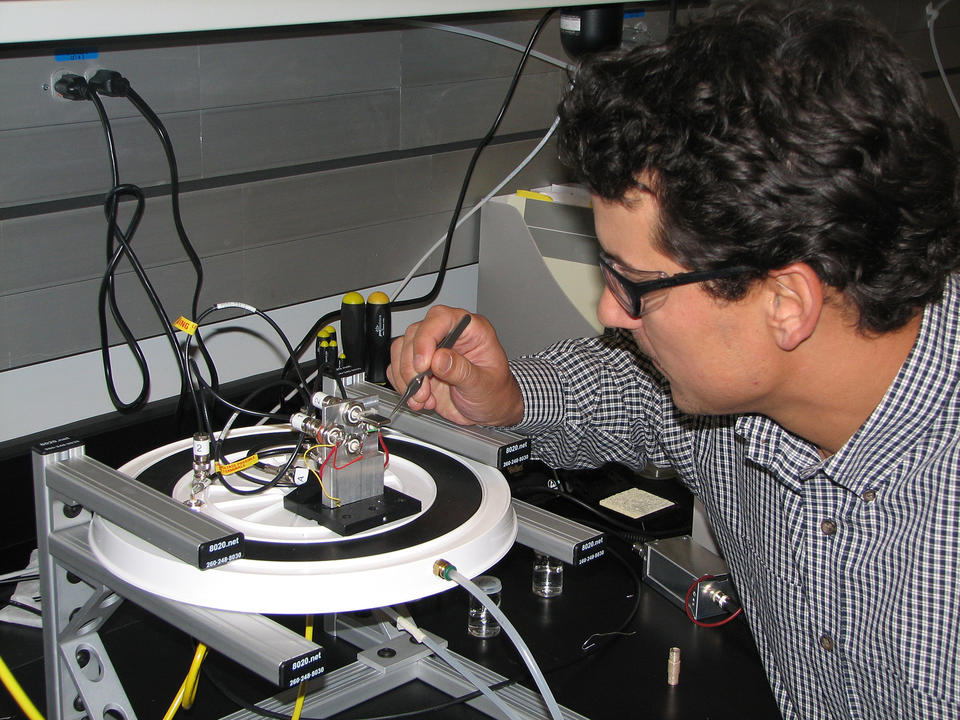 NIST chemist James Kushmerick adjusts test apparatus demonstrating a prototype silver nanoswitch.