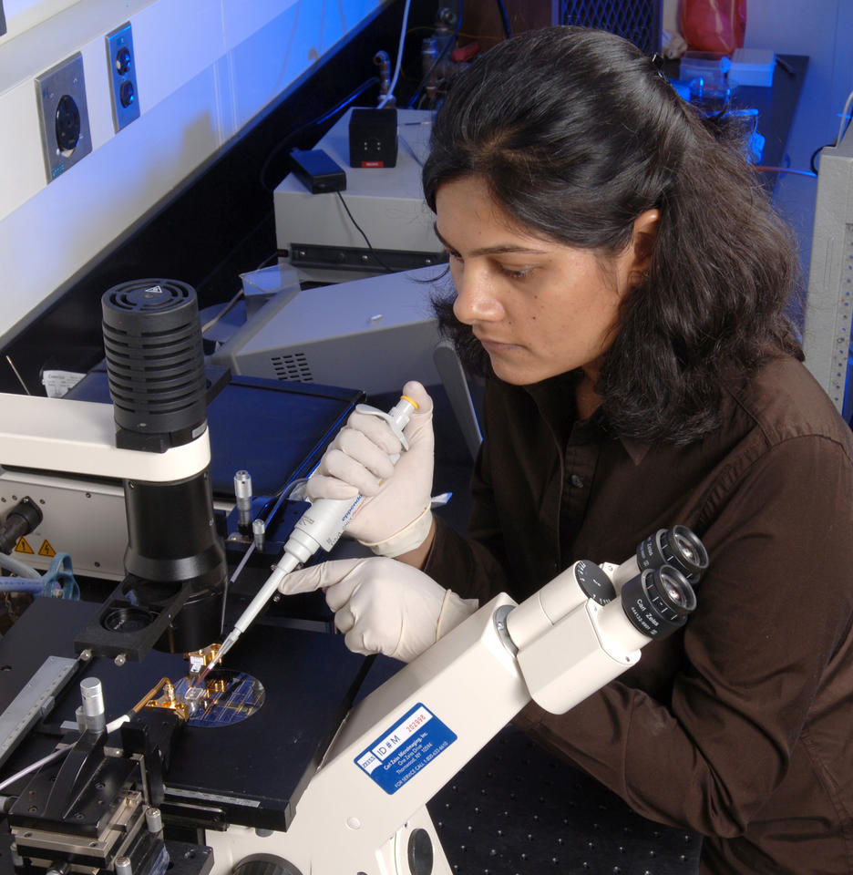 Photo of NIST researcher Jayna Shah working with the NIST micro microwave oven.