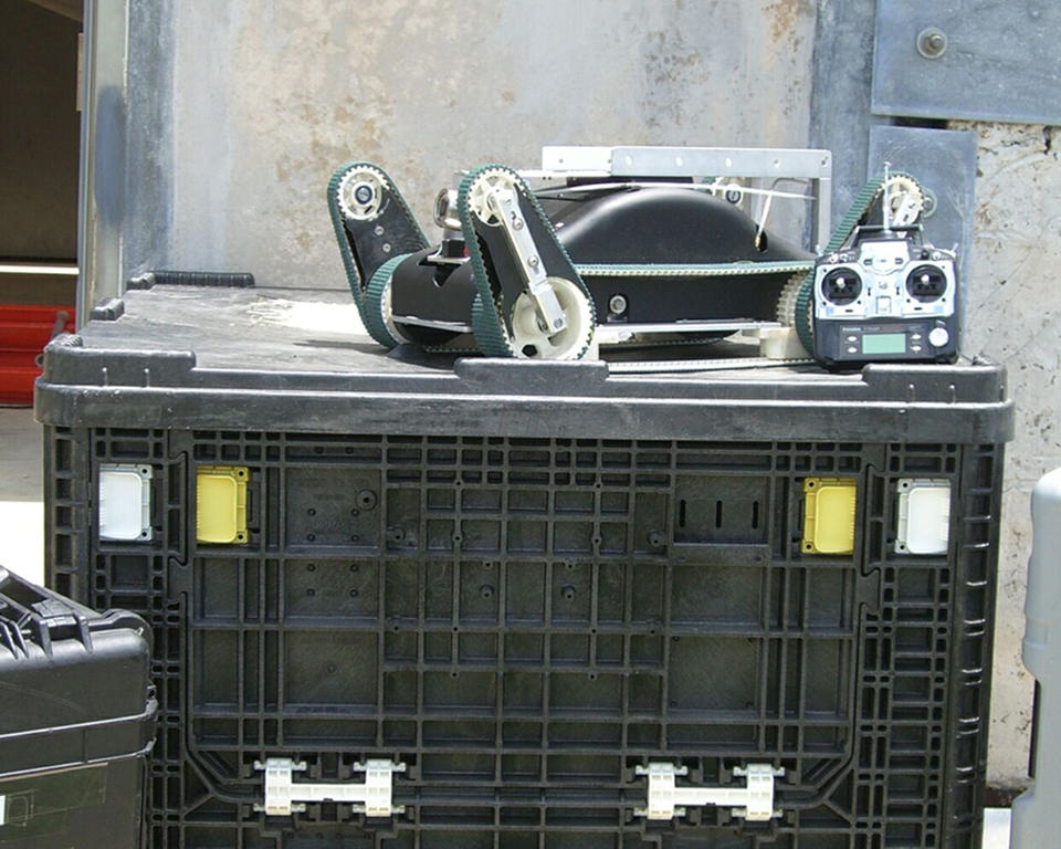 Urban search and rescue robot and its control unit sit atop one of the packing crates 