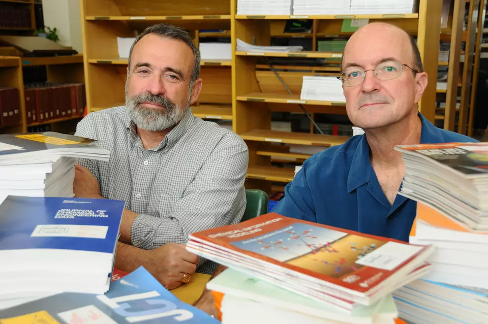 Frenkel and Chirico in front of a stack of books