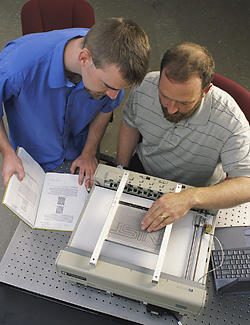 Researchers John Roberts and Oliver Slattery using the tactile graphic display device