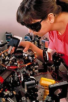 NIST physicist Deborah Jin aligns an infrared laser for a magneto optical trap as part of a project to create "superatoms."